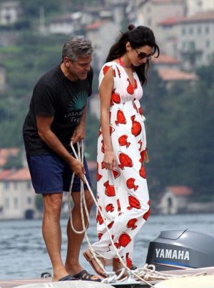 Amal Alamuddin in a red and white maxi dress while on a boat with George Clooney in Lake Como.jpg
